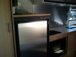 range burners and sink are beneath hinged smoked-lexan covers