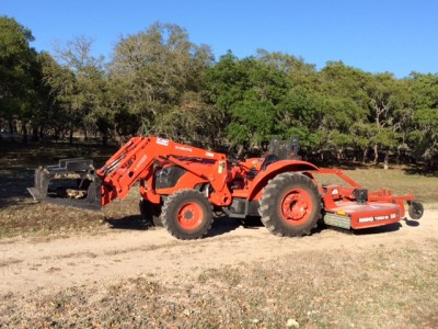 Kubota 7040 SUHD with 6’ grapple and 8’ shredder capable of shredding 3”dia growth